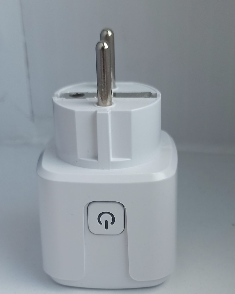 A white plug-in smart plug with a round power button and its two pins visible.