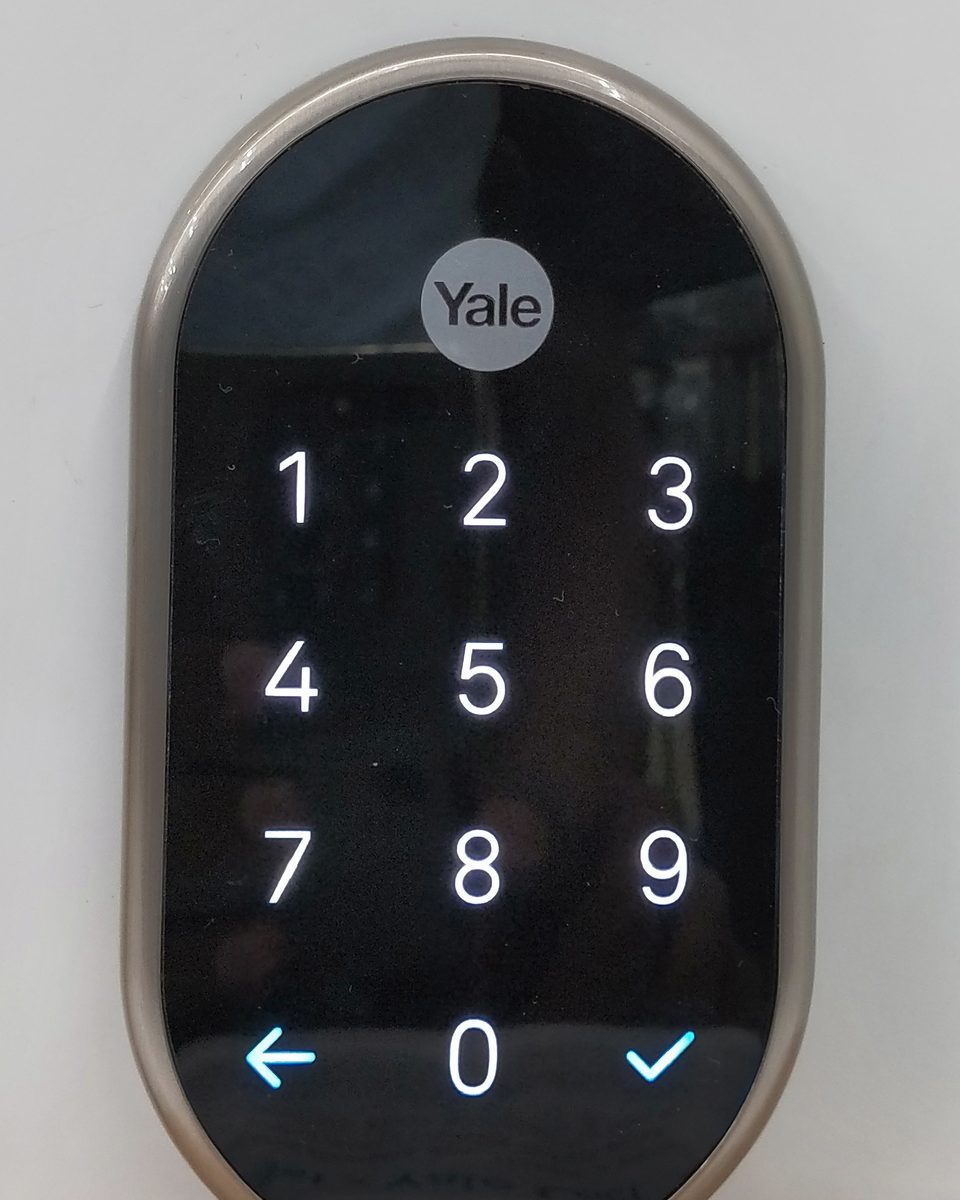 The touch keypad of a Nest x Yale smart lock with the digits lit.